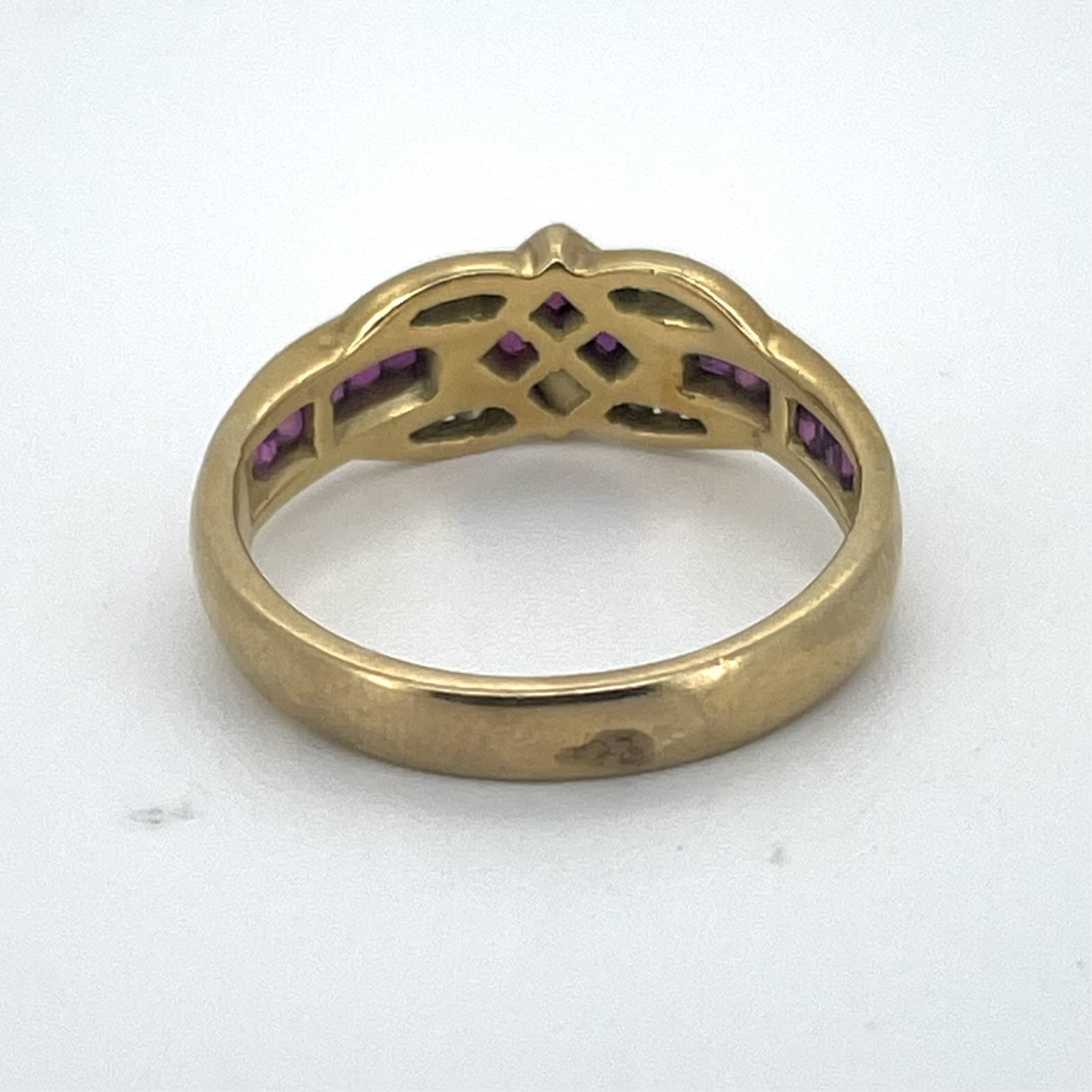 A yellow metal, stamped 18ct, ruby and diamond cluster ring, with ten stone graduated ruby set shoulders, size N, gross weight 4.2 grams.